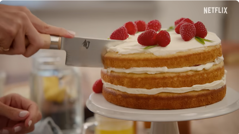 Meghan Markle cutting a cake in the trailer for her lifestyle show on Netflix "With Love, Meghan" | Source: Youtube/Netflix